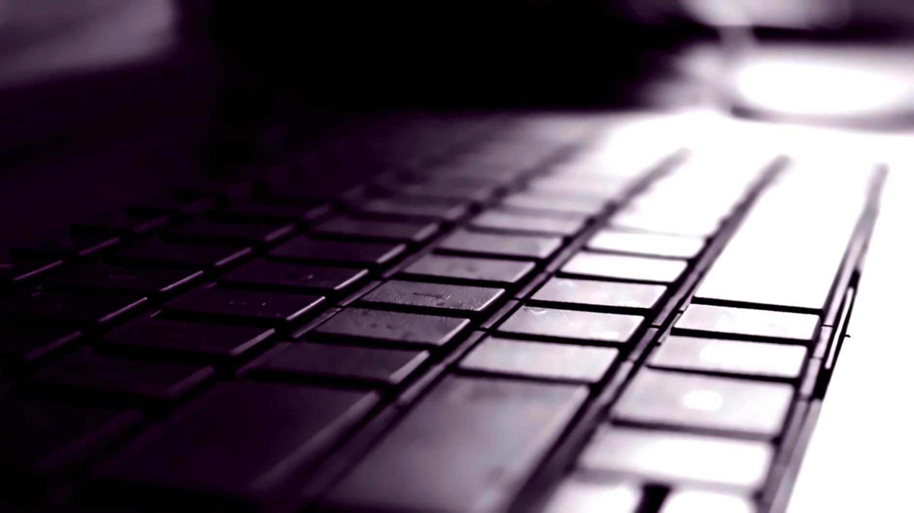 Students working through complex DevOps scenarios on multiple monitors showing system architectures