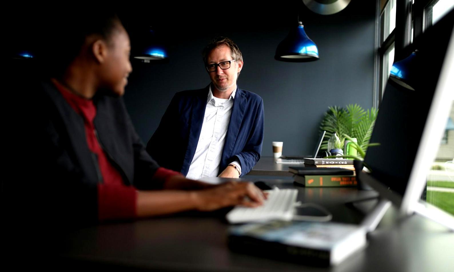 DevOps professionals collaborating on infrastructure projects in modern workspace